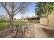 Backyard area with stone fire pit, outdoor seating, mature trees and covered porch at 865 S Everett St, Lakewood, CO 80226
