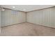 Finished basement room featuring neutral carpet, paneled walls, and comfortable lighting at 865 S Everett St, Lakewood, CO 80226