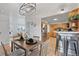 Inviting dining area next to kitchen featuring wood floors, stylish decor, and a welcoming ambiance at 865 S Everett St, Lakewood, CO 80226