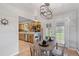 Charming dining area with wood floors, views of kitchen, and French doors that lead to the backyard at 865 S Everett St, Lakewood, CO 80226