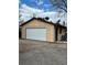 Garage exterior with white door, side service door, and an enclosed storage area at 865 S Everett St, Lakewood, CO 80226