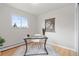 Bright home office with hardwood floors, large window, and modern glass desk at 865 S Everett St, Lakewood, CO 80226