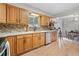 Charming kitchen features oak cabinets, modern stainless-steel appliances, and breakfast bar seating at 865 S Everett St, Lakewood, CO 80226