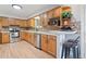Functional kitchen with stainless steel appliances, light wood cabinets, and bar seating for casual dining at 865 S Everett St, Lakewood, CO 80226