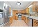 Well-equipped kitchen with stainless steel appliances, light wood cabinets, and a functional layout for cooking at 865 S Everett St, Lakewood, CO 80226