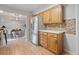 Bright kitchen showcases stainless steel refrigerator, wood cabinets, and access to the dining area at 865 S Everett St, Lakewood, CO 80226