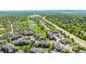 Picturesque aerial view of community nestled amongst mature trees and serene ponds by the highway at 7433 S Quail Cir # 1924, Littleton, CO 80127