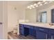 Bright bathroom with a toilet and vanity with a large mirror, modern lighting at 7433 S Quail Cir # 1924, Littleton, CO 80127