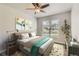 Bright bedroom featuring a ceiling fan, and a large window letting in natural light at 7433 S Quail Cir # 1924, Littleton, CO 80127