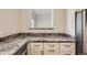 Close-up of granite countertop and white cabinets in this condo kitchen at 7433 S Quail Cir # 1924, Littleton, CO 80127