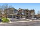 Well-maintained exterior with attached garages, parking, and lovely landscaping at 7433 S Quail Cir # 1924, Littleton, CO 80127