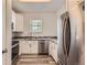 Well-lit kitchen with white cabinets, stainless steel appliances, and granite countertops at 7433 S Quail Cir # 1924, Littleton, CO 80127