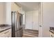 Bright kitchen featuring stainless steel appliances, granite countertops, and white cabinets at 7433 S Quail Cir # 1924, Littleton, CO 80127