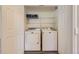 Laundry closet with washer and dryer units and a wire shelf above at 7433 S Quail Cir # 1924, Littleton, CO 80127