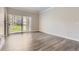 Open-concept living area featuring wood floors and large sliding glass doors to a private balcony at 7433 S Quail Cir # 1924, Littleton, CO 80127