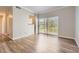 Bright living room featuring wood floors and sliding glass doors leading to a private balcony at 7433 S Quail Cir # 1924, Littleton, CO 80127