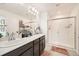 Bathroom with double sink vanity, tile flooring, and walk-in shower at 21613 E 59Th Pl, Aurora, CO 80019