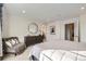 Tranquil bedroom featuring soft carpet, dresser, accent chair, and a large window at 21613 E 59Th Pl, Aurora, CO 80019