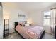 Cozy bedroom features a queen-size bed with stylish bedding and soft gray carpet, illuminated by natural light at 21613 E 59Th Pl, Aurora, CO 80019