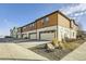 Modern townhomes with two-car garages feature contemporary architectural details and professional landscaping at 21613 E 59Th Pl, Aurora, CO 80019