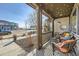 Cozy covered front porch with wicker seating and colorful pillows, perfect for relaxing outdoors at 21613 E 59Th Pl, Aurora, CO 80019