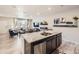 Open-concept living space with granite island, stainless steel dishwasher, and a view into the Gathering room at 21613 E 59Th Pl, Aurora, CO 80019