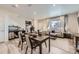 Open-concept living space featuring dining and seating areas with natural light at 21613 E 59Th Pl, Aurora, CO 80019