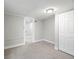 A basement room with tile ceiling, flush mount light fixture, closet, and a doorway at 3855 N Cook St, Denver, CO 80205