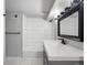 A remodeled bathroom featuring a tiled shower/tub combo with modern vanity and dark fixtures at 3855 N Cook St, Denver, CO 80205