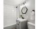 Clean, updated bathroom featuring white subway tile, a gray vanity, and modern fixtures at 3855 N Cook St, Denver, CO 80205