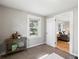 Bright bedroom with a view to the living room features a desk and stylish decor at 3855 N Cook St, Denver, CO 80205