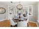 Dining room area with hardwood floors, built-in cabinet, and stylish, modern lighting fixture at 3855 N Cook St, Denver, CO 80205