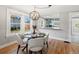 Bright dining area features hardwood floors and an elegant, modern lighting fixture at 3855 N Cook St, Denver, CO 80205