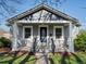 Inviting home featuring a cozy covered porch and well-maintained landscaping at 3855 N Cook St, Denver, CO 80205