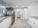 Updated kitchen with stainless steel refrigerator and views to an adjacent bathroom at 3855 N Cook St, Denver, CO 80205