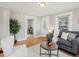 Cozy living room with wood floors, white trim, and natural light streaming through a window at 3855 N Cook St, Denver, CO 80205
