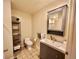 Bathroom with tiled floor, toilet, dark vanity, and matching mirror at 300 W 11Th Ave # 10D, Denver, CO 80204