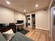 Neutral bedroom featuring a laundry closet, desk, and light wood floors at 300 W 11Th Ave # 10D, Denver, CO 80204