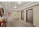Hallway with elevators, carpet floors, mirrors, and table with decorative vases at 300 W 11Th Ave # 10D, Denver, CO 80204