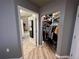 Hallway view into bathroom and walk-in closet with custom shelving and ample storage space at 300 W 11Th Ave # 10D, Denver, CO 80204
