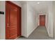 Apartment building hallway with neutral carpet and red doors at 300 W 11Th Ave # 10D, Denver, CO 80204