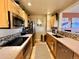 Modern kitchen with stainless appliances, light wood cabinetry, and stylish mosaic backsplash at 300 W 11Th Ave # 10D, Denver, CO 80204