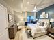 Staged bedroom features a king bed, light wood floors, and ensuite access to a private balcony at 300 W 11Th Ave # 10D, Denver, CO 80204