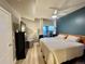 Bedroom with a ceiling fan, dark accent wall, and balcony access for fresh air at 300 W 11Th Ave # 10D, Denver, CO 80204
