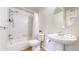 Cozy bathroom with tub-shower combination and pedestal sink with round mirror at 11374 Xavier Dr # 202, Westminster, CO 80031