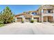 The townhome has a well-manicured lawn, a stone facade, and individual garages at 11374 Xavier Dr # 202, Westminster, CO 80031