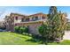 Exterior of the townhome with well-kept lawn and tasteful landscaping at 11374 Xavier Dr # 202, Westminster, CO 80031