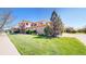 Beautiful multi-story home showcasing lush green lawn and an inviting stone facade at 11374 Xavier Dr # 202, Westminster, CO 80031