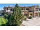 A spacious two-car garage with a beautiful stone exterior and well-maintained landscaping at 11374 Xavier Dr # 202, Westminster, CO 80031