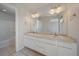 Double sink bathroom with white cabinets and tiled flooring at 23541 E Portland Way, Aurora, CO 80016